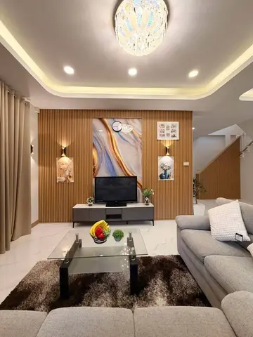 Living corner with slatted wood wall panels. The furniture shown is staging