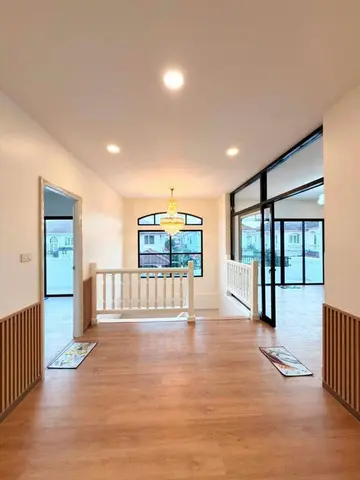 Upstairs, looking towards the arched window at the end of the landing