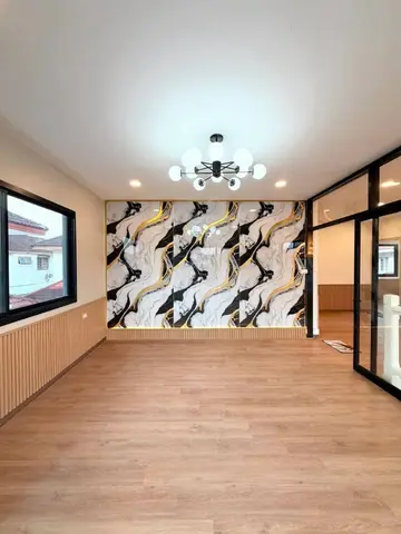 Upstairs room with the marble-pattern wall and glass doors to the landing
