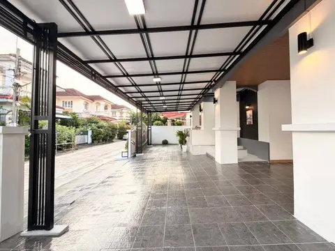 Tiled carport floor looking out towards the soi