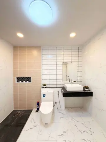 Another bathroom with a toilet and a countertop basin